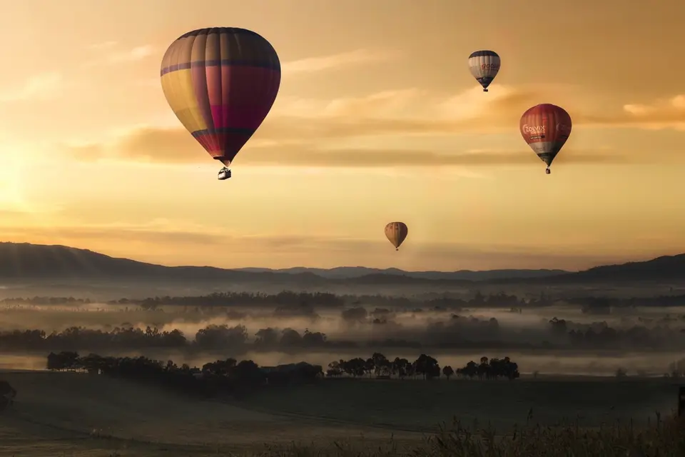 Gün doğumunda vadi üzerinde sıcak hava balonları